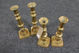 Two pairs of antique brass candlesticks