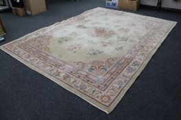 A large Chinese embossed carpet on beige ground