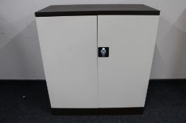 A metal double door stationary cupboard