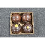 A set of four vintage wooden lawn bowls