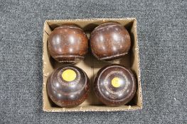 A set of four vintage wooden lawn bowls