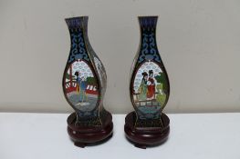 A pair of Japanese cloisonne vases depicting Geisha on circular wooden stands