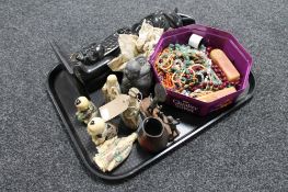 A tray of costume jewellery, carved eastern resin figures,