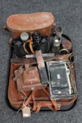 A tray of leather vintage satchel, cameras, case, binoculars,