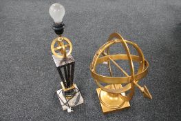 A contemporary metal armillary sphere and a table lamp