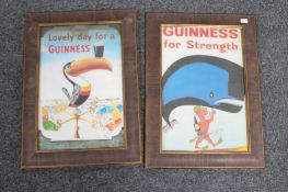 A pair of framed Guinness advertising prints