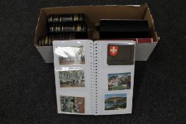 A box of seven albums of 20th century postcards