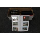 A box of seven albums of 20th century postcards