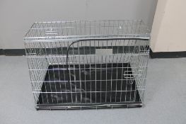 A folding metal dog cage,