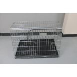 A folding metal dog cage,