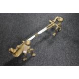 A pair of Victorian brass fire dogs and two brass companion pieces with claw handles