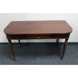 A Victorian mahogany D-end table fitted with a drawer