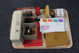 A tray of first day covers, costume jewellery, 1937 RAF pocket book, stamp albums, die cast car,