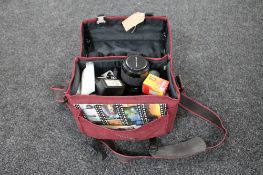 A camera bag containing Praktika camera,