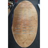 A Kinnasand hand stitched oval wool carpet on peach ground,