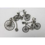 Two miniature silver bicycles and a penny farthing with stand, tallest 4.