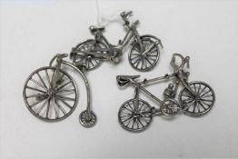 Two miniature silver bicycles and a penny farthing with stand, tallest 4.