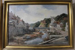 A gilt framed Denys Garle oil on canvas, Cornish village by a river,