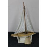 A mid 20th century wooden pond yacht on stand named Ivory Tower