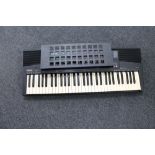 A Yamaha PSR-215 electric keyboard with lead