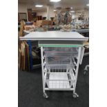 A metal medial trolley with adjustable top,