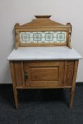 An Edwardian oak tiled back and marble topped washstand