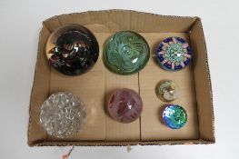 A box of seven assorted glass and crystal paperweights