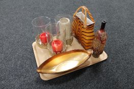 A tray of contemporary glass ware, three candle holders on metal base.