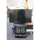 A Hitachi 32" LCD TV with remote together with a Dimplex coal-effect electric fire