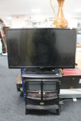 A Hitachi 32" LCD TV with remote together with a Dimplex coal-effect electric fire