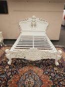 A contemporary white double carved bed frame