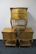 A set of three painted gilt two drawer bedside tables with bergere undershelf