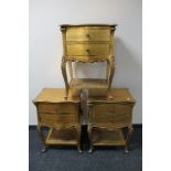 A set of three painted gilt two drawer bedside tables with bergere undershelf