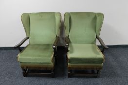 A pair of mid century wingback armchairs in green fabric