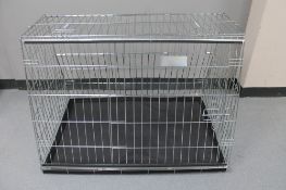 A folding metal dog cage,