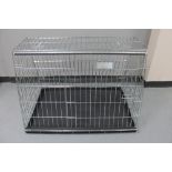 A folding metal dog cage,