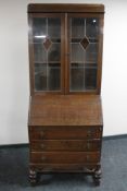 An early 20th century oak leaded glass door bureau bookcase
