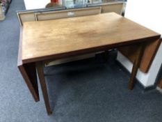 A mid century teak flap sided table