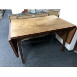 A mid century teak flap sided table