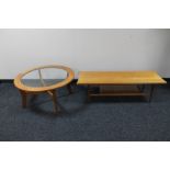 A circular teak glass topped coffee table together with a rectangular teak coffee table with