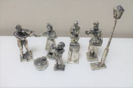 A collection of white metal decorative figures - Musician, Chestnut roaster,