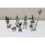 A collection of white metal decorative figures - Musician, Chestnut roaster,