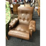 A mid century brown buttoned leather swivel chair on chrome base