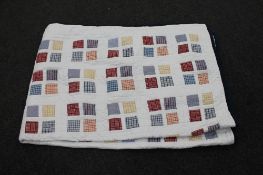 A hand stitched patchwork quilt