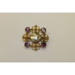 An amethyst and pearl gold brooch