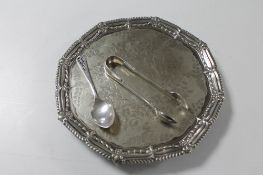 A plated card tray on claw and ball feet together with a plated teaspoon and pair of tongs