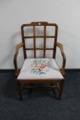 An antique oak tapestry seated armchair