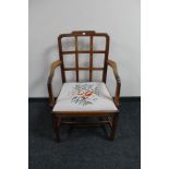 An antique oak tapestry seated armchair