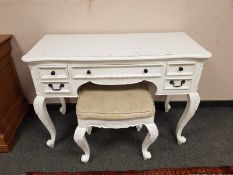 A contemporary white dressing table on cabriole legs with matching stool, width 110 cm.