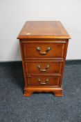 An inlaid yew wood bedside chest